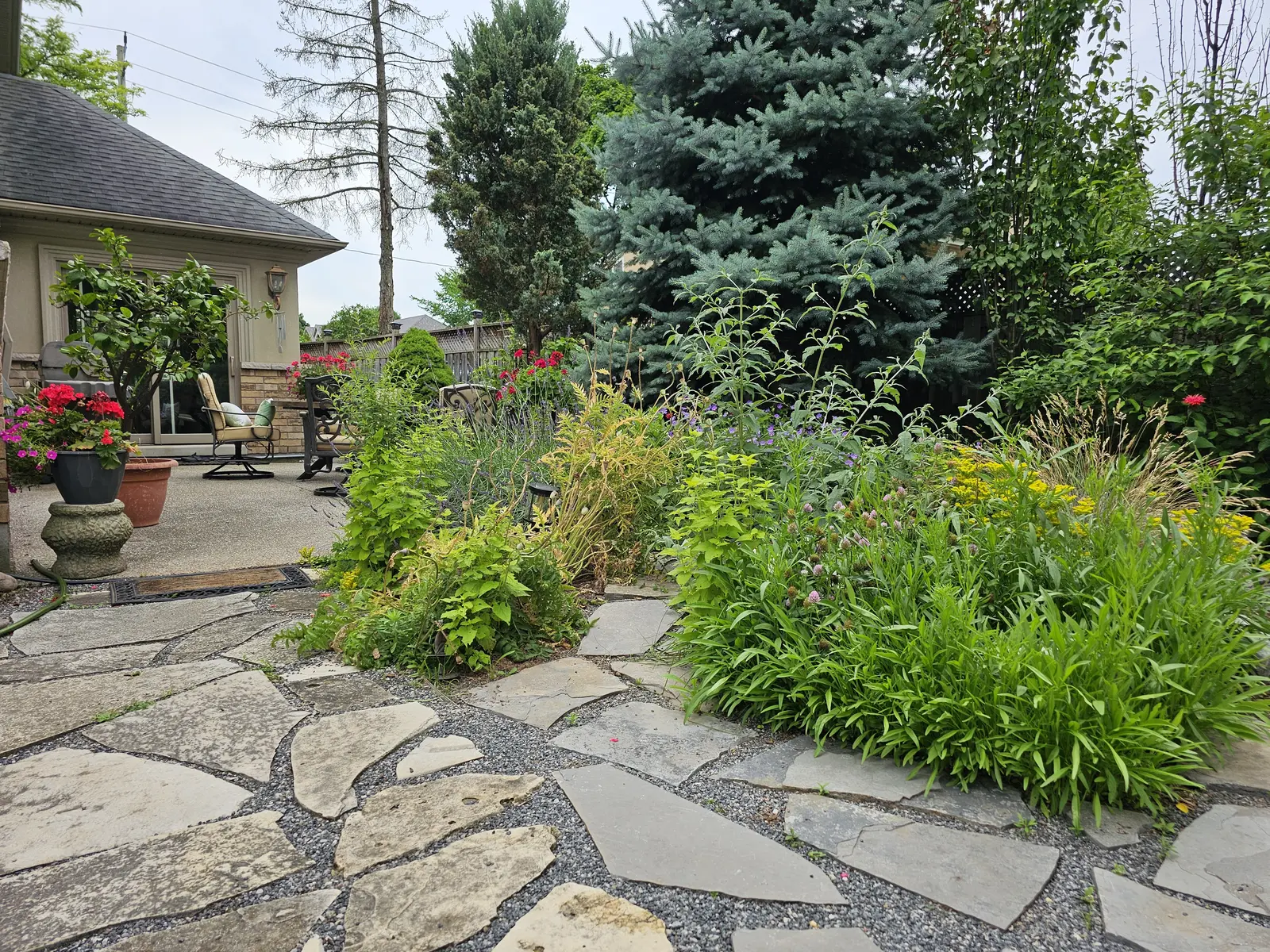 Flagstone patio with lush perennial borders
